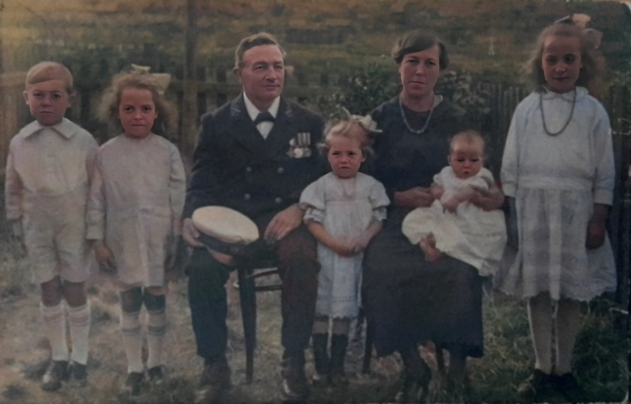 George William Dunn in naval uniform with medals, with wife Margaret and five children — c.1919